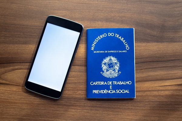 Brazilian document work and social security ( Carteira de Trabalho e Previdencia Social) with smartphone Brazilian document work and social security ( Carteira de Trabalho e Previdencia Social) with smartphone