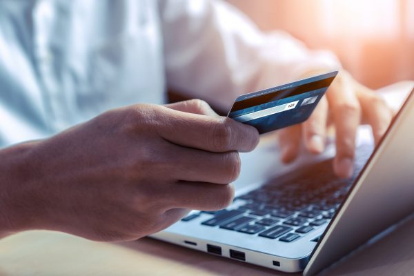 Young man use credit card for shopping payment online on laptop computer application or website. E-commerce and online shopping concept. Young man use credit card for shopping payment online on laptop computer application or website. E-commerce and online shopping concept.